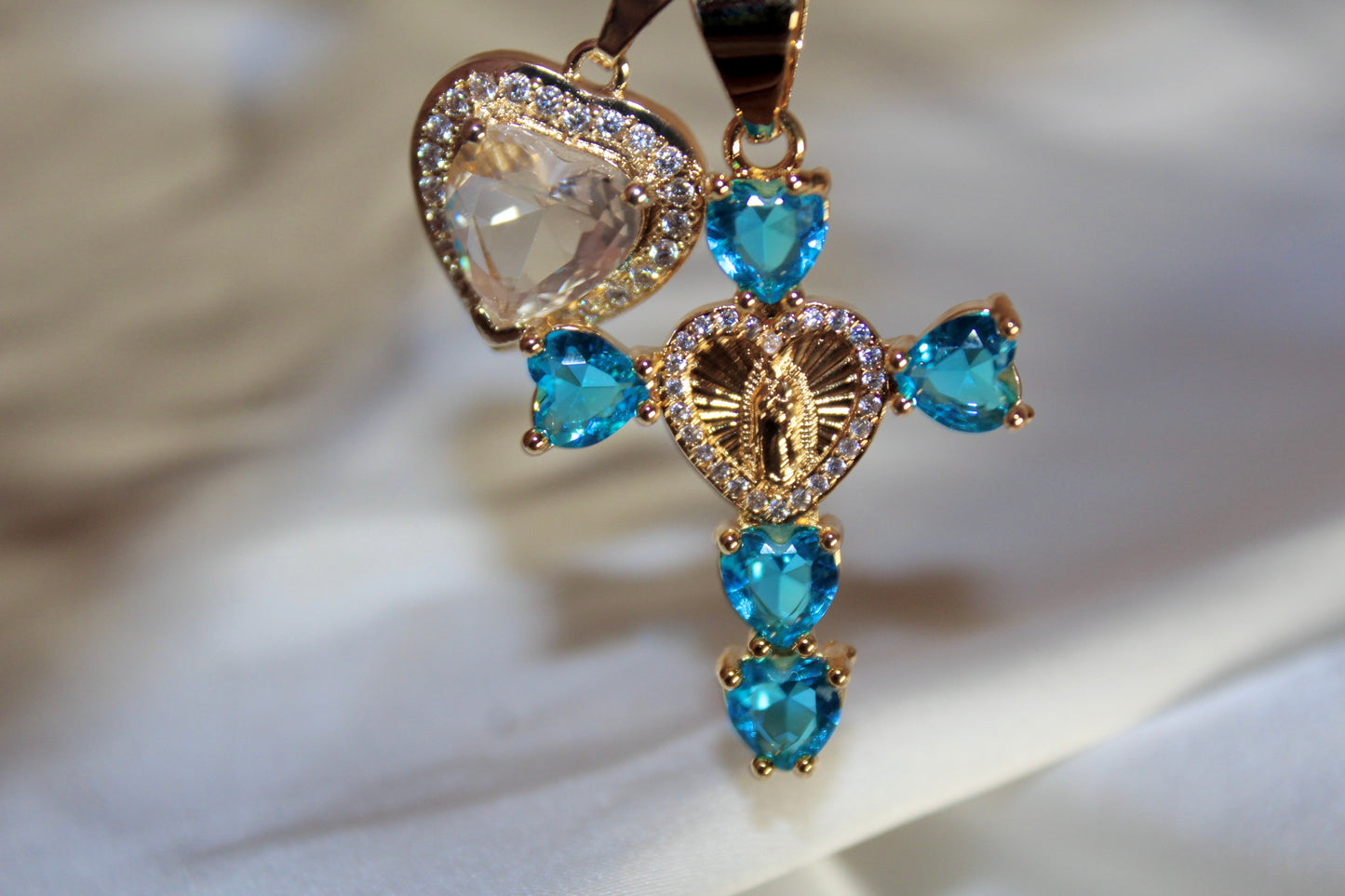 Blue heart shaped cross with silver heart